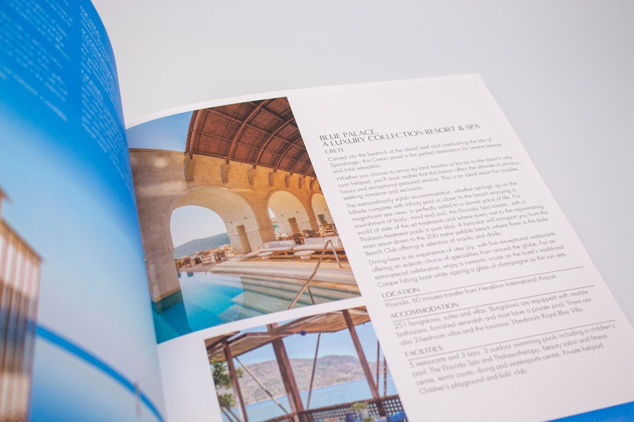 an open travel brochure with a picture of a holiday resort with a bright blue pool