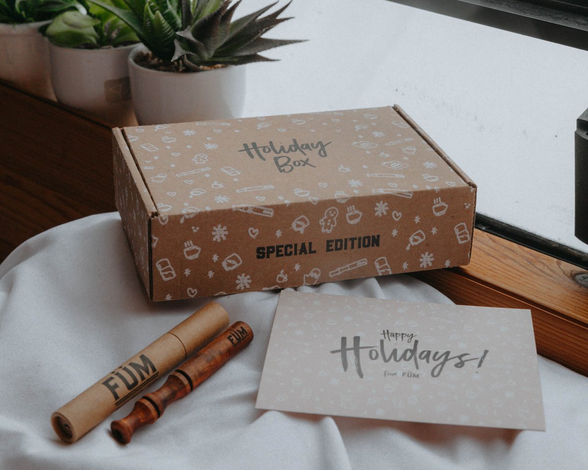 Cardboard gift box, card and tube displayed on a table